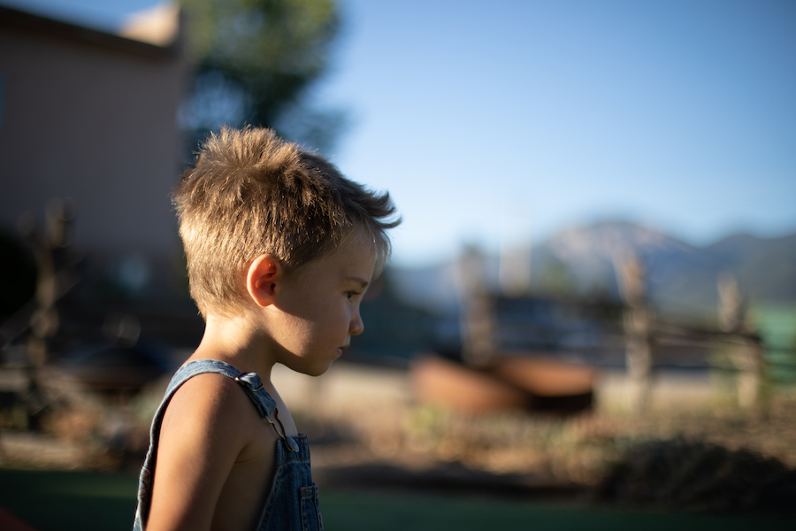 Young boy standing outside