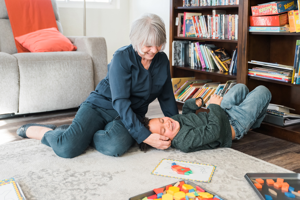 Grandmother with Grandchild playing on rug