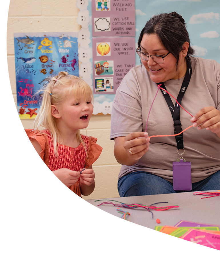 Child care provider with child in classroom