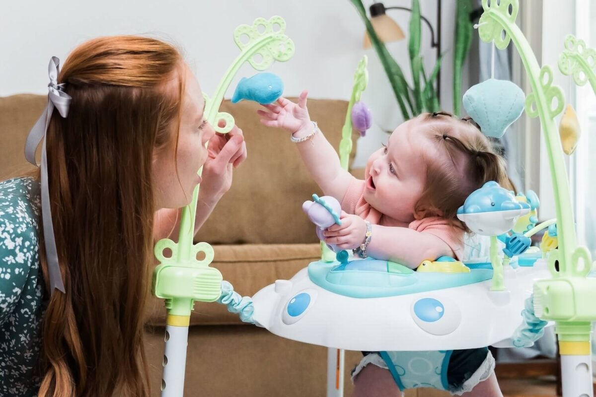 Mother with her baby playing with toys.